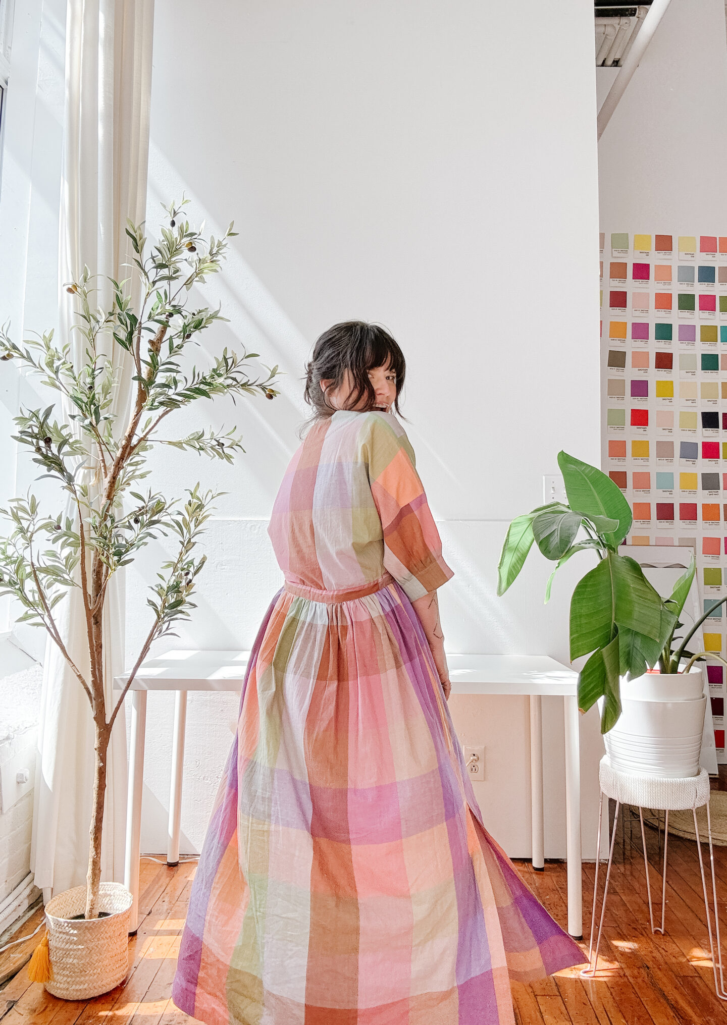 girl wearing maxi colourful dress in an office space