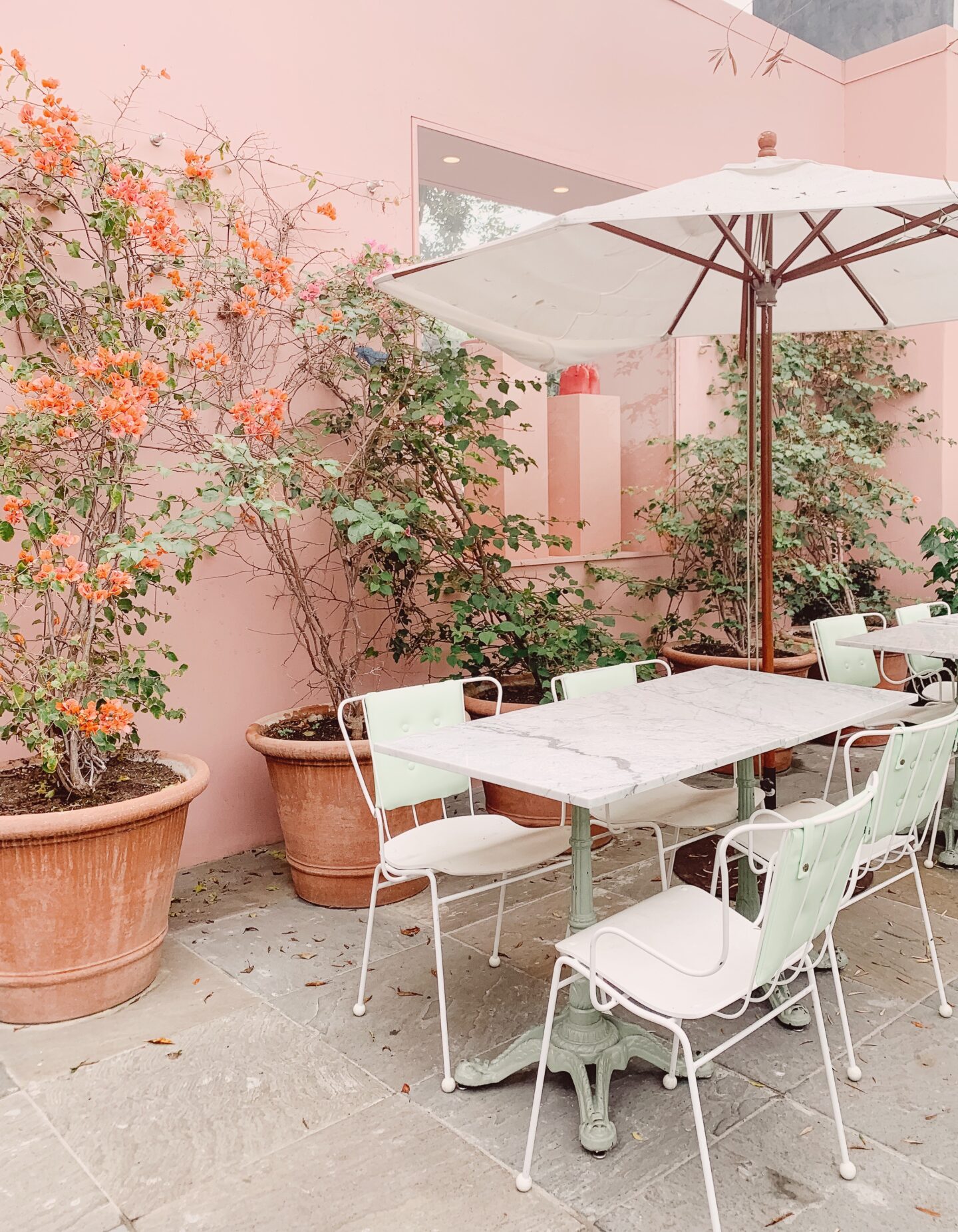 a pink terrace with table and chairs in Los Angeles