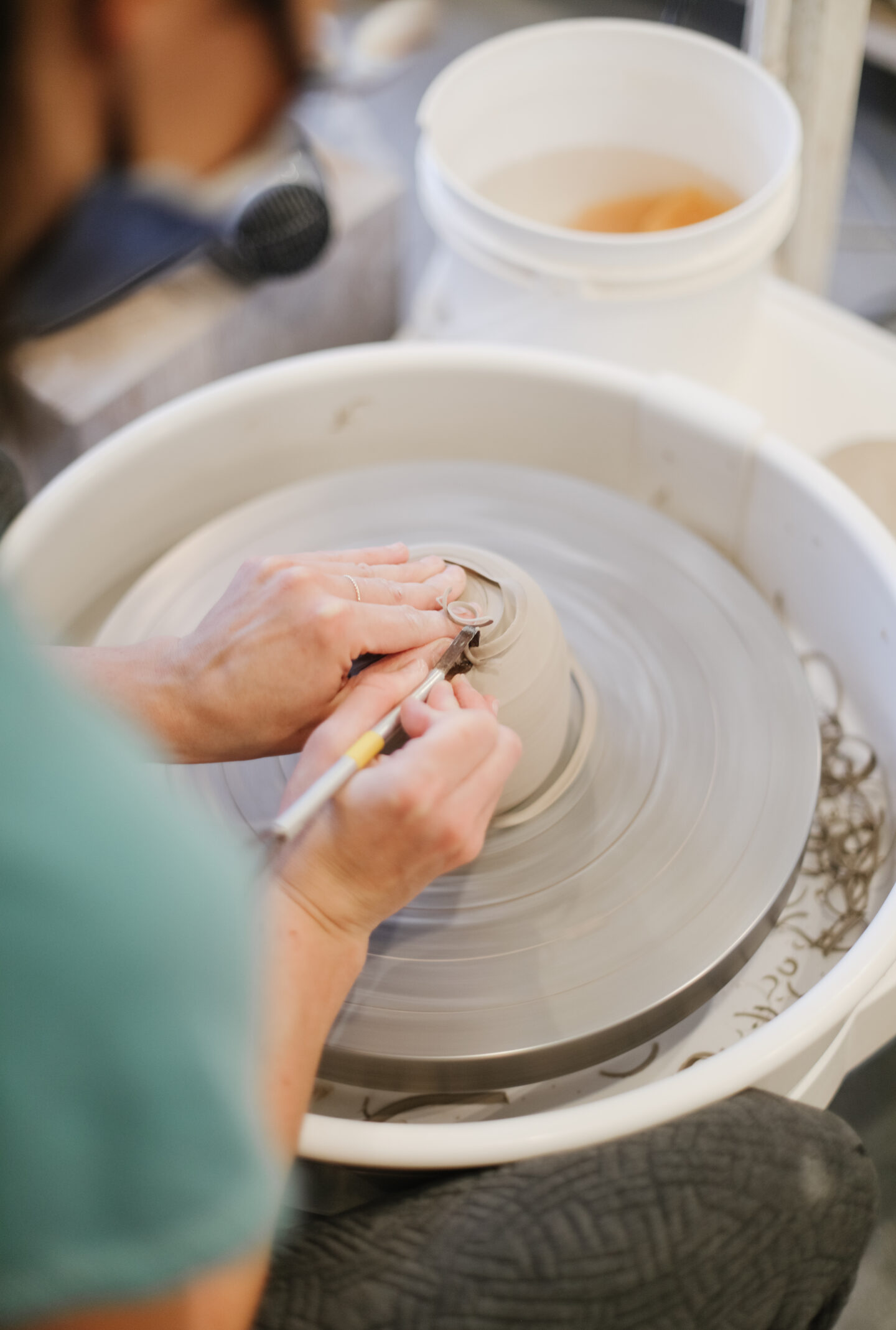 Mom creating pottery, embracing hands-on art projects as part of mindful parenting